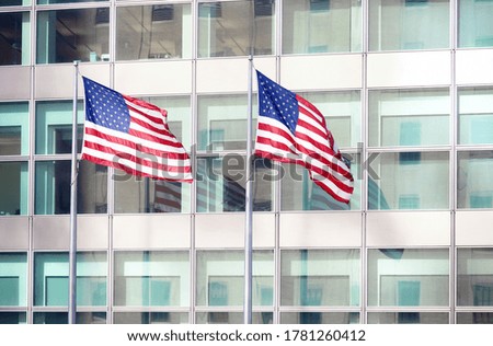 Two American Flags in front of an office building, New York City, USA.