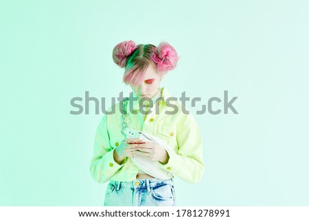 Beautiful woman pink hair and fashionable clothes lifestyle phone in hands Studio music bright design
