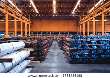 Pack of steel round bar stack in layer inside large distribution warehouse. Steel warehouse logistics operations. Royalty-Free Stock Photo #1781285168