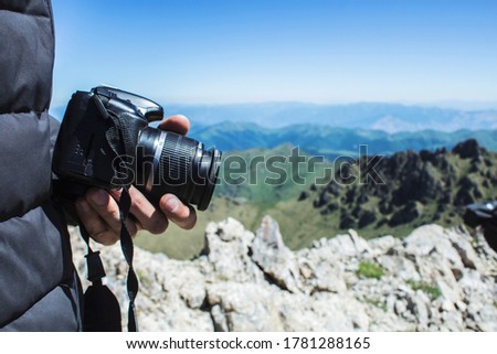 the photographer takes pictures on the mountain during the day