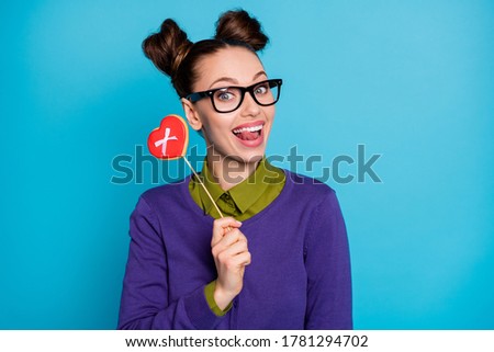Close-up portrait of her she nice attractive pretty funny cheerful cheery girl eating caramel candy licking lip isolated on bright vivid shine vibrant blue green teal turquoise color background