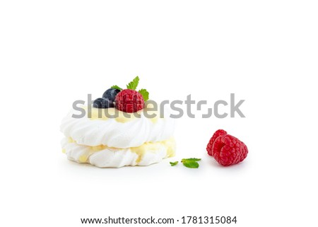 Mini pavlova dessert with raspberries and blueberries on a white background