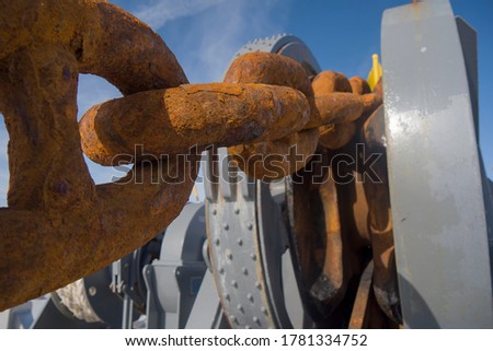 Ship rusty anchor chain on a winch.