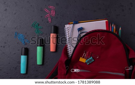 stationary items on dark concrete surface as schooling concept