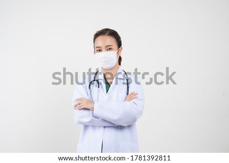 Portrait of an Asian female doctor wearing a medical mask in a medical uniform. Isolated white background