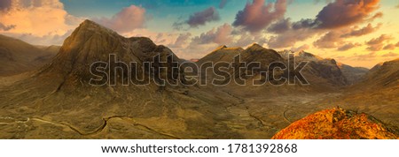 sunrise View of the valley and mountains with tourist on hill at Glencoe, Highlands, Scotland, Great britain.