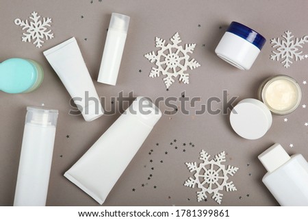 Winter care cosmetics on a colored background top view, place to insert text, minimalism. Skin care, skin hydration
