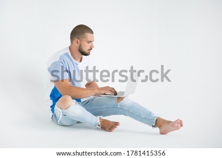 young man with a laptop on a white background