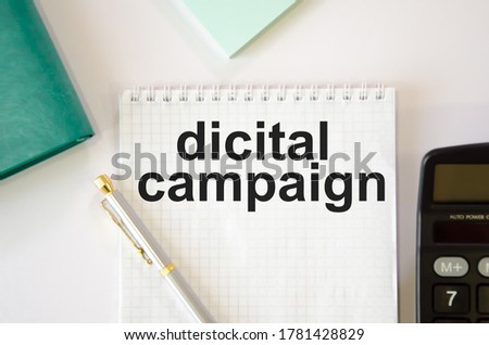 on the notebook is written the text dicital campaign. High quality photo