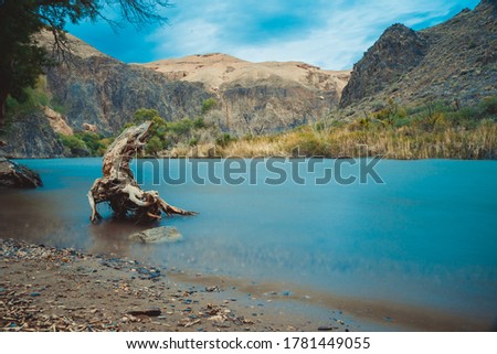 Beautiful river in the Charyn canyon and blue cloudy sky with clouds in Kazakhstan