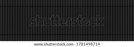 Panorama of Modern black stone wall with stripes texture and seamless background