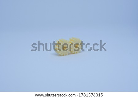 two yellow plastic gear on a white background
