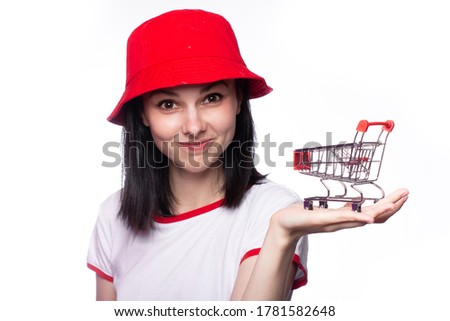 woman with small shopping cart. Handsome man collision with shopping trolley. Sale, discount and online shopping concept. Girl with mini shopping cart. Copy space
