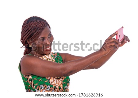 portrait of a beautiful adult woman taking photo on the mobile phone while smiling.