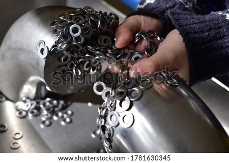 Hands with ferromagnet rings magnetized to the metal rack Royalty-Free Stock Photo #1781630345