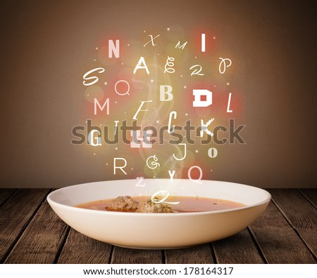 Colorful letters coming out of home cook soup bowl on wood deck