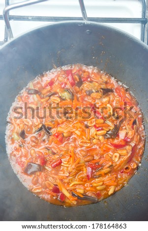 Chinese food during preparation in a frying pan 