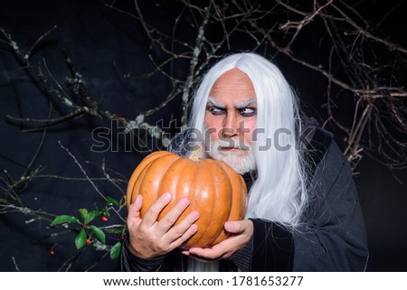 Devil vampire man. Evil wizard hold orange pumpkin. Handsome Demon with Jack o lantern. Happy Halloween. Mature man magician in witch hat. Traditional food. Fantasy horror Halloween. Halloween banner.