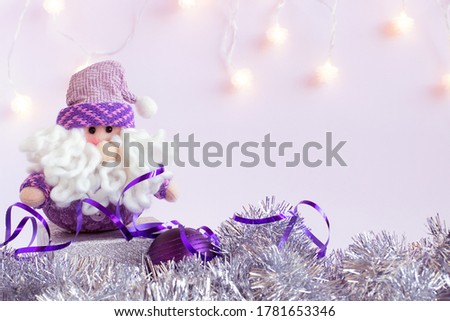 Toy Santa Claus with purple ball. New Year composition for background.