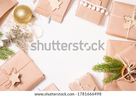 several gift boxes wrapped in kraft paper on a white background, eco friendly christmas concept, zero waste gifts for the new year, white background, frame from boxes, copy space