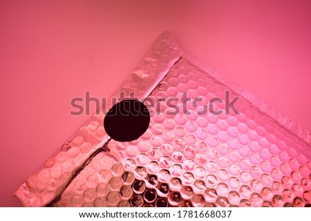 Silver packaging envelope with pink light