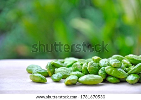 Bitter bean, Twisted cluster bean,
Stink bean on wooden cutting board. Close up. Food Wallpaper