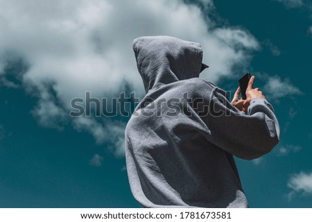 Guy taking picture with the sky behind him