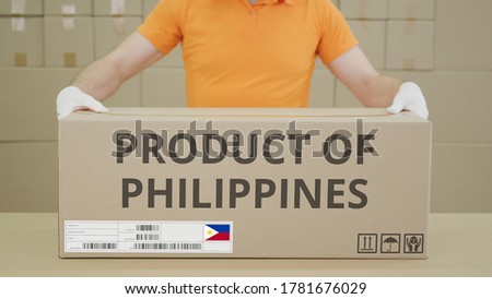 PRODUCT OF PHILIPPINES printed text on the side of a big cardboard box in a warehouse