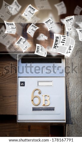 Post box with daily newspapers flying out