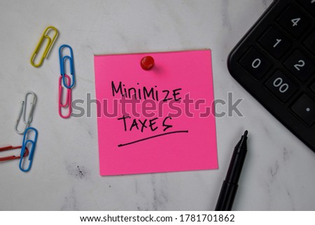 Minimize Taxes text on sticky notes isolated on office desk. Royalty-Free Stock Photo #1781701862