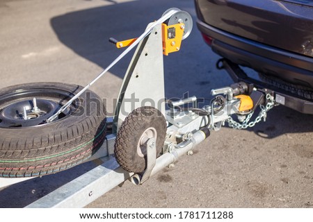tow hitch for towing a trailer by a passenger car, trailer drawbar with a spare wheel Royalty-Free Stock Photo #1781711288