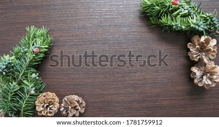 Pine cones, pine leaves and nuts on a dark brown background. Concept of autumn season.