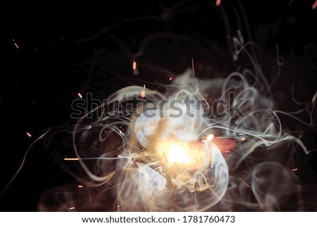 A bright flash of light and a sheaf of sparks in a cloud of smoke. Miniature Universe. Design elements for invitation, wedding cards, greeting cards, Silvester day, christmas decoration.