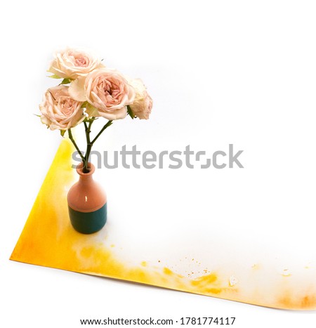 Small cute tiny vase with dry tea rose bouquet and hand painted watercolor blot spot isolated on white background. Photo with free blank copy space for text. For cards, posters, website decoration