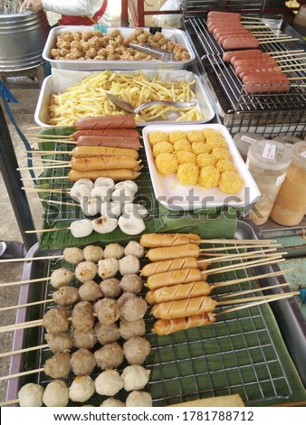 grilled food, thai street food on the market, picture not clear, no focus, have noise, have blur.