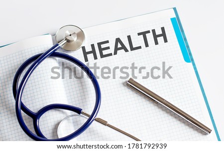 Paper with text HEALTH on a table with stethoscope