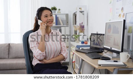 korean woman resting during work catching up with friend on phone. asian young female making a phone call in front of desktop in her studio. work from home concept Royalty-Free Stock Photo #1781808209