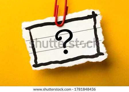 Question Mark paper is isolated on the yellow background.