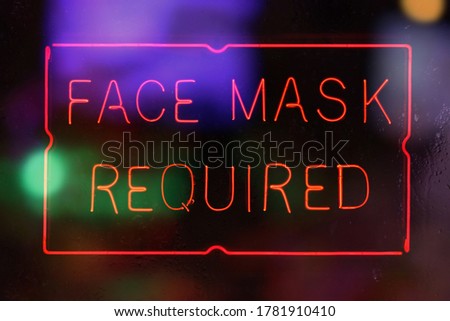 Neon Face Mask Required Sign in Rainy Window