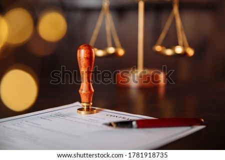 Notary's public pen and stamp on a contract. Notary public tools Royalty-Free Stock Photo #1781918735