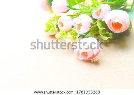 Sweet bouquet of roses on brown background.