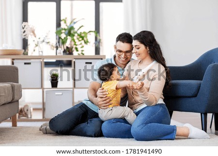 family and people concept - happy mother, father and baby son sitting on floor at home Royalty-Free Stock Photo #1781941490