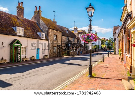 A view up the traditional High Street in the town of Rottingdean, Sussex, UK in summer Royalty-Free Stock Photo #1781942408