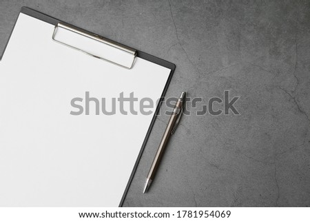 Top view of Document Board and pen on gray background and copy space
