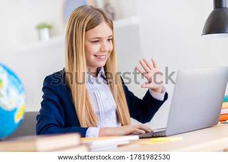 Close-up profile side view portrait of her she nice attractive pretty cheerful small little long-haired girl attending web conference waving hi in light white class room indoors