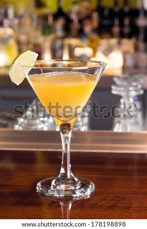 Yellow drink in cocktail glass