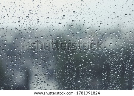 Rain drops on window with blurred  background,Rainy day,Water drop on glass,Feeling lonely concept.