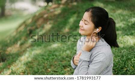 Young woman smile and listen music with headphone