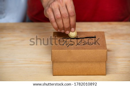 coins pooring into a tip box