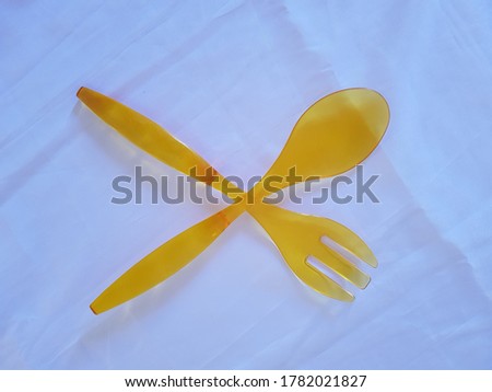 Spoon and fork, transparent yellow color